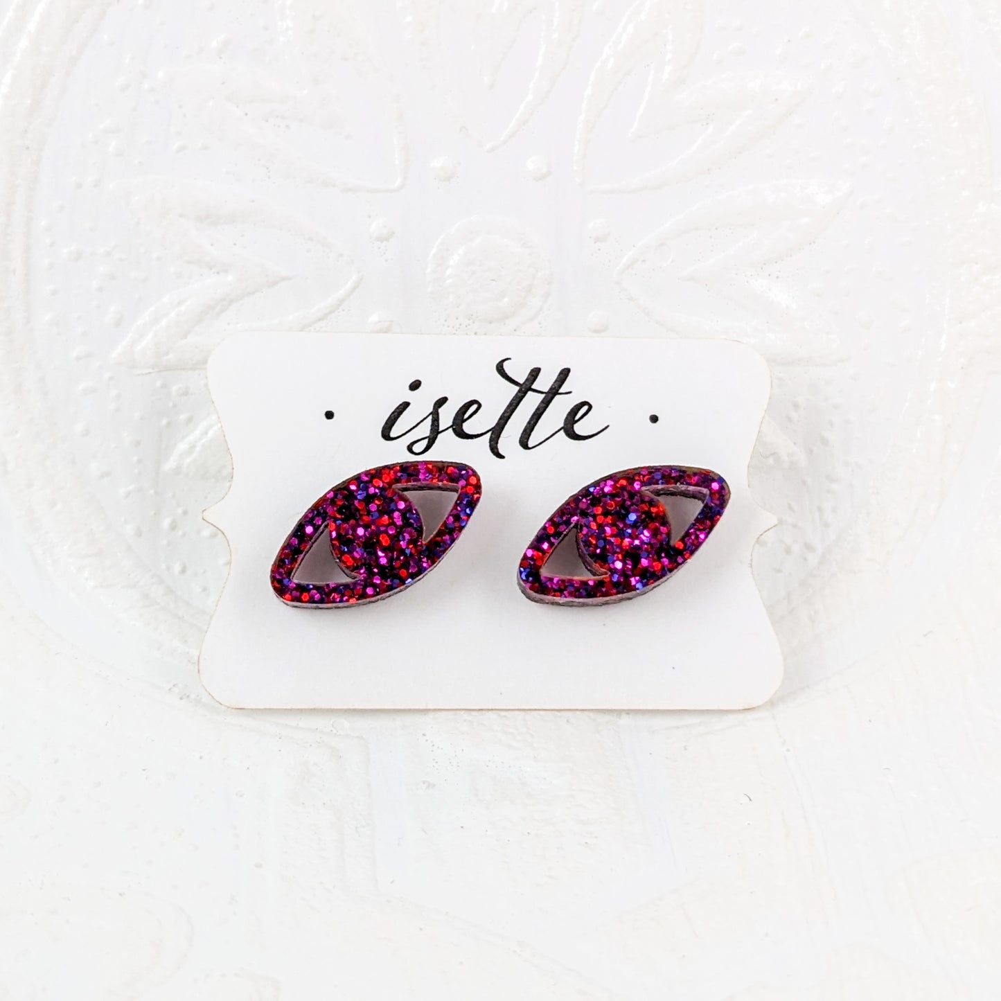 Peepers - Eye shaped stud earrings made with ruby sparkle acrylic and stainless steel posts on Isette card